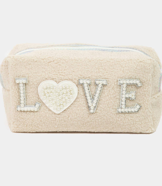 Beige pouch with 'LOVE' text and heart design on a white background