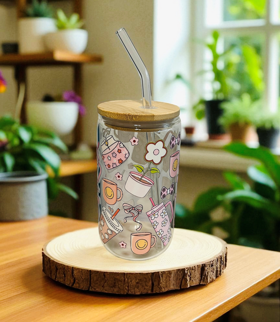 Decorative tumbler with floral designs on a wooden coaster in a home setting with plants.