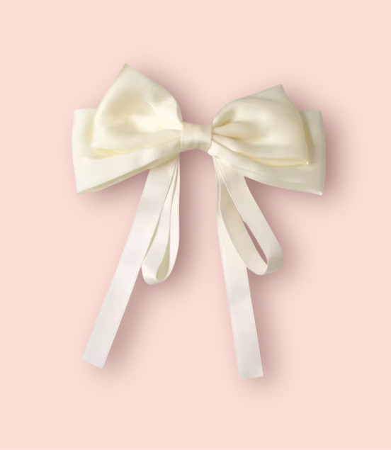 Large white satin bow on a pink background