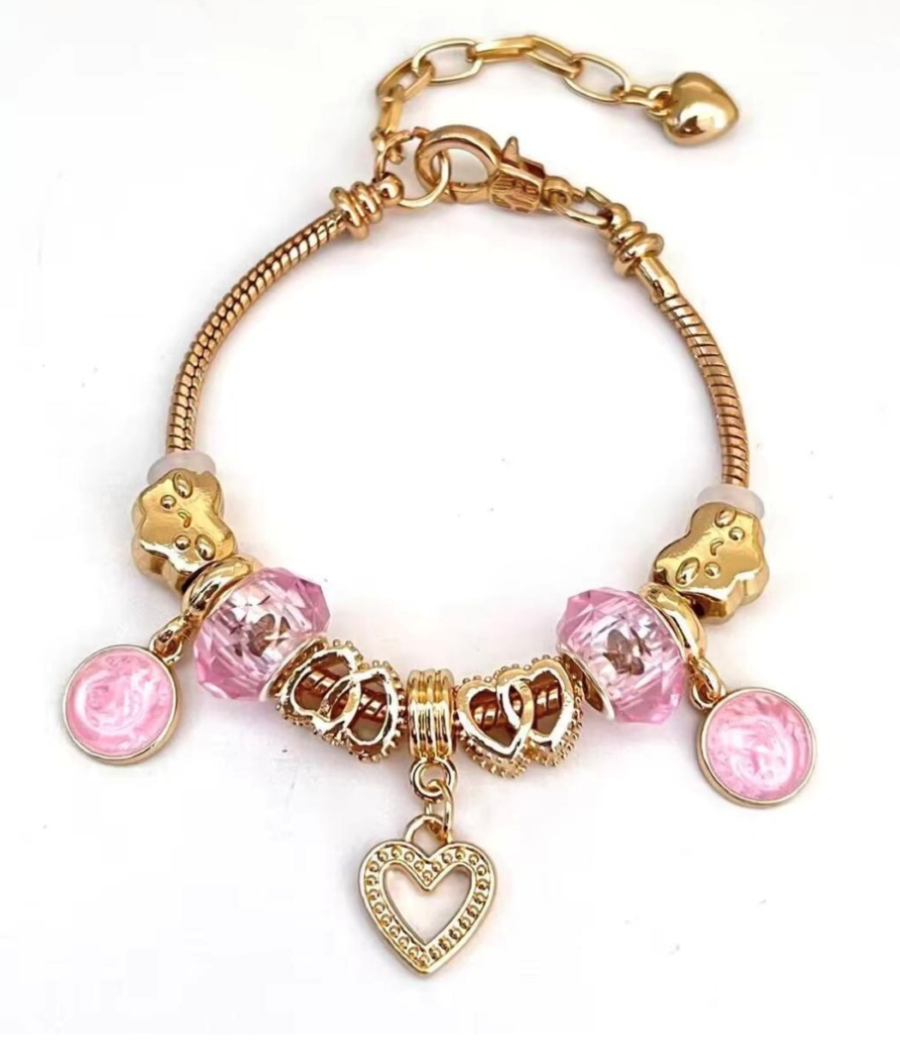 Gold Bracelet with pink crystal bead, heart and pattern shape charms