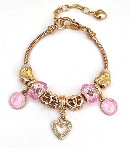 Gold Bracelet with pink crystal bead, heart and pattern shape charms