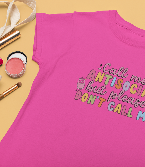 Pink t-shirt with colorful text on a yellow background