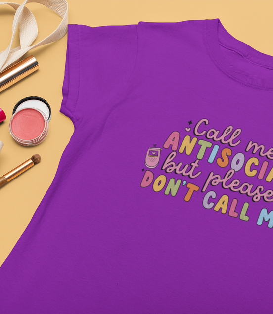 Purple t-shirt with colorful text on a yellow background