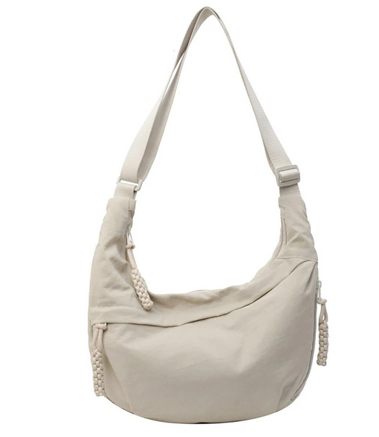 Beige handbag with a strap on a white background