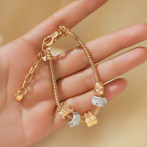 Gold Bracelet with crown and sparkling charms