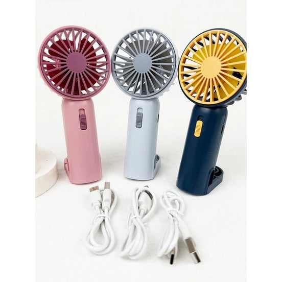 Three handheld fans in pink, gray, and blue with charging cables on a white background