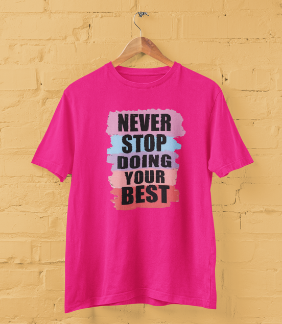 Pink t-shirt with motivational quote on a yellow brick wall