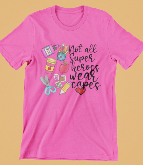 Pink t-shirt with educational-themed design and text on a yellow background