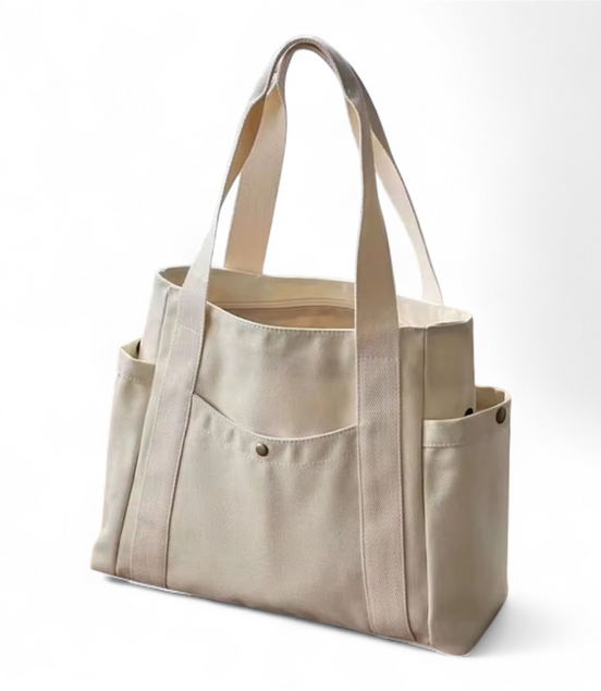 Beige tote bag with multiple pockets on a white background