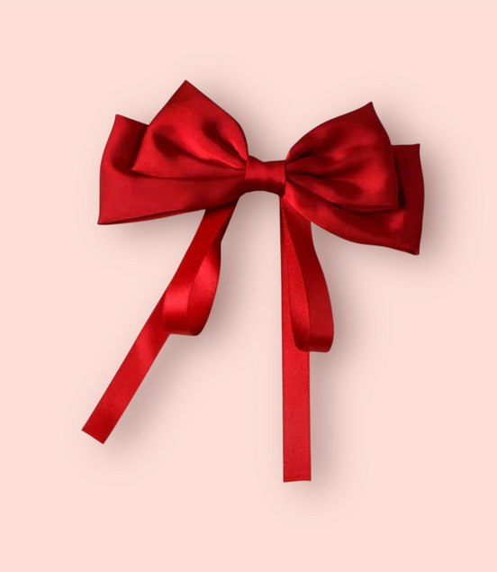 Red satin bow on a beige background
