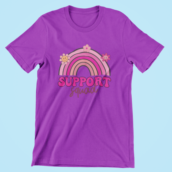 Purple t-shirt with a rainbow and flowers design on a light blue background