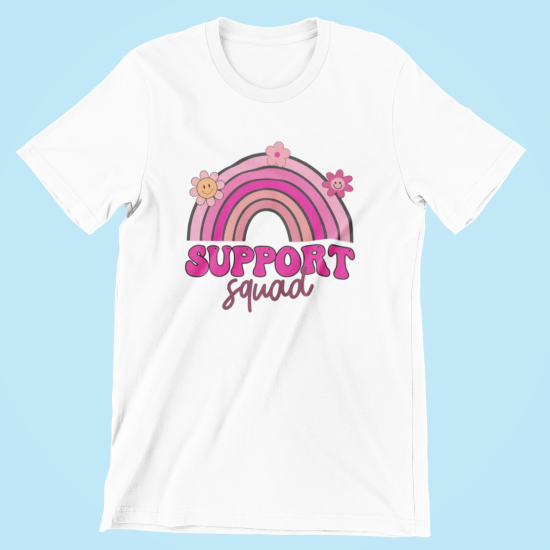 White t-shirt with a pink rainbow and flowers design on a light blue background