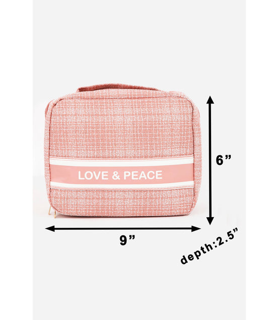 Pink toiletry bag with 'LOVE & PEACE' text and dimensions on a white background