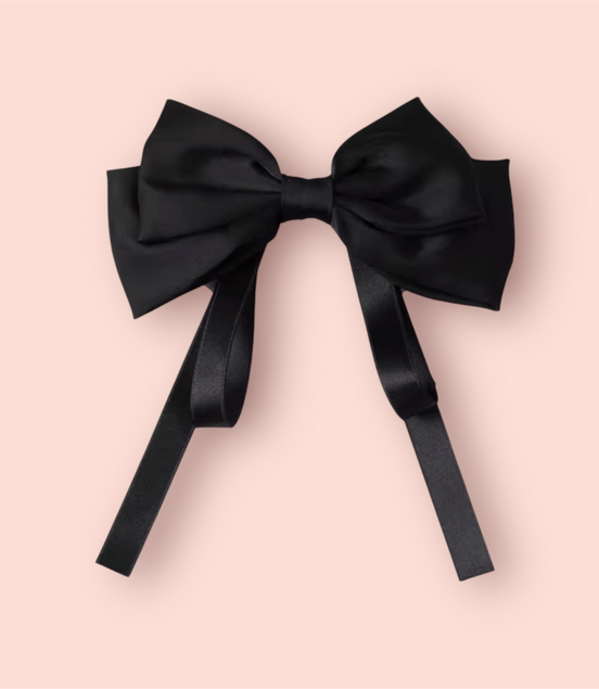 Black bow on a pink background