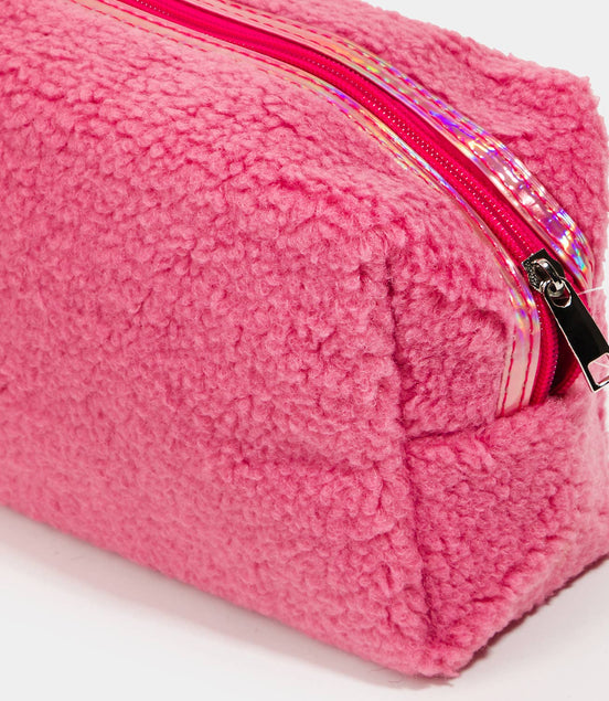 Pink fuzzy pouch with a iridescent zipper on a white background